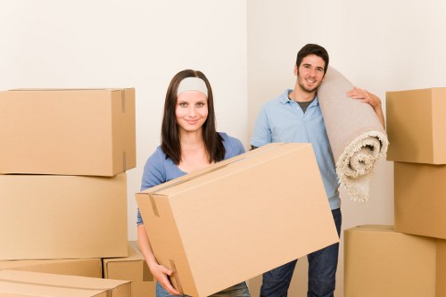 Organized storage unit with boxes, furniture, and packing supplies